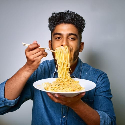 An AI generated image of a man eating spaghetti ... strangely.